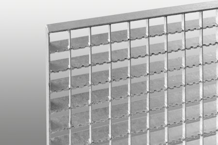 Close-up view of a metal grating panel featuring a grid design with evenly spaced slots and a smooth metallic finish.