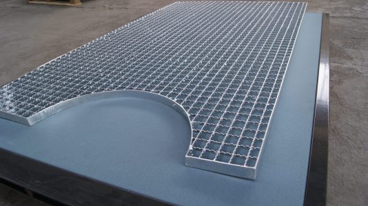 a metal grate on a blue surface