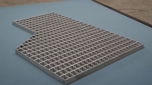 a metal grid on a blue surface