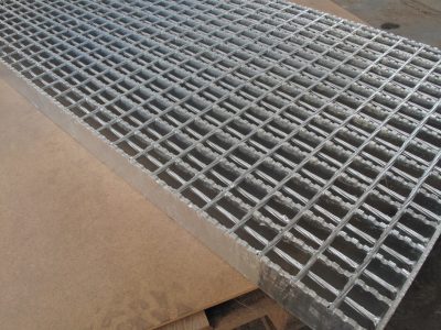 a metal grate on a wood surface